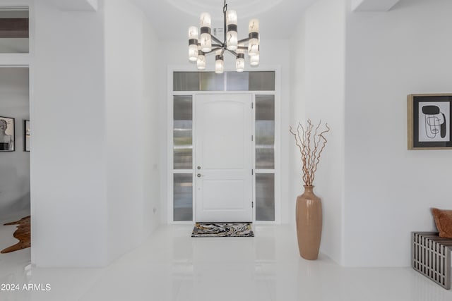 tiled foyer with a notable chandelier