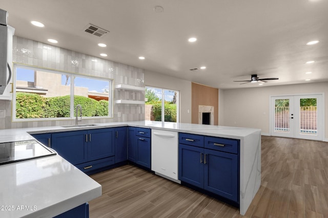 4913 E Acoma Dr, Scottsdale, AZ 85254 - kitchen with a sink, dishwasher, a peninsula, blue cabinetry, and a ceiling fan