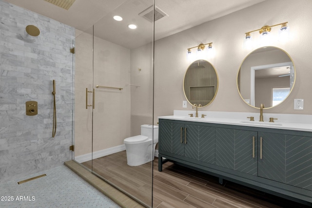 4913 E Acoma Dr, Scottsdale, AZ 85254 - full bath featuring double vanity, a tile shower, toilet, wood finish floors, and recessed lighting