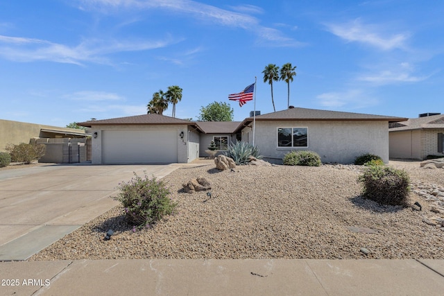 4913 E Acoma Dr, Scottsdale, AZ 85254 - view of front facade featuring driveway, stucco siding, and an attached garage