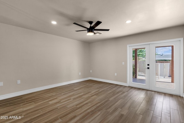 4913 E Acoma Dr, Scottsdale, AZ 85254 - empty room with wood finished floors, baseboards, ceiling fan, recessed lighting, and french doors
