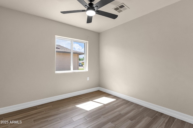 4913 E Acoma Dr, Scottsdale, AZ 85254 - spare room featuring dark wood-style flooring, baseboards, and a ceiling fan