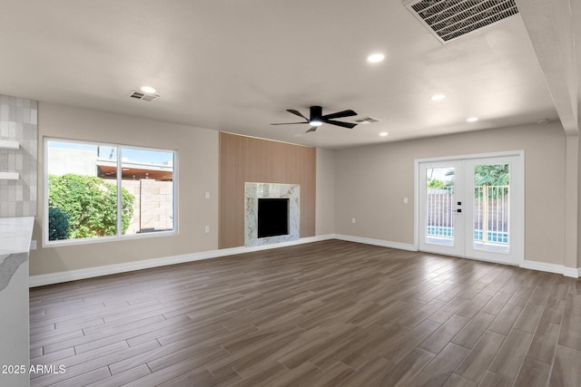 4913 E Acoma Dr, Scottsdale, AZ 85254 - unfurnished living room featuring a ceiling fan, dark wood finished floors, baseboards, recessed lighting, and french doors