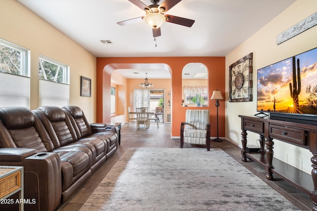 living area featuring ceiling fan, visible vents, and baseboards