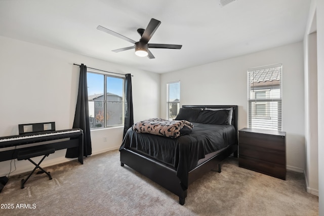 bedroom with light colored carpet and ceiling fan