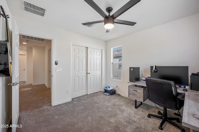 home office with light carpet and ceiling fan