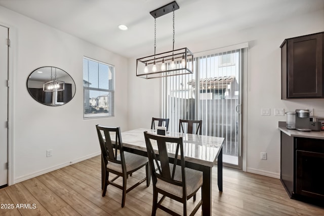 dining space featuring plenty of natural light and light wood-type flooring