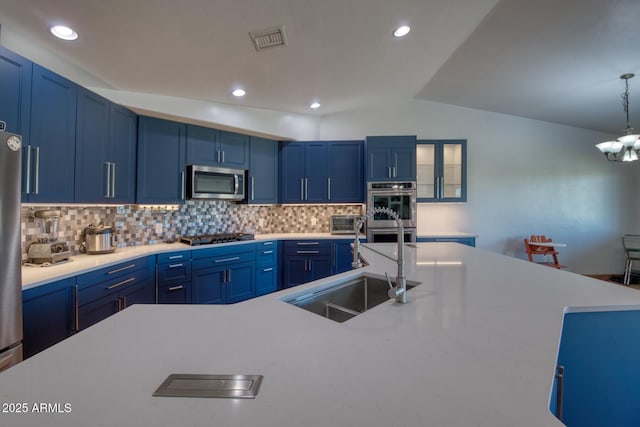 3298 W Monte Vista Trl, Benson, AZ 85602 - kitchen with blue cabinetry, stainless steel appliances, light countertops, and a sink
