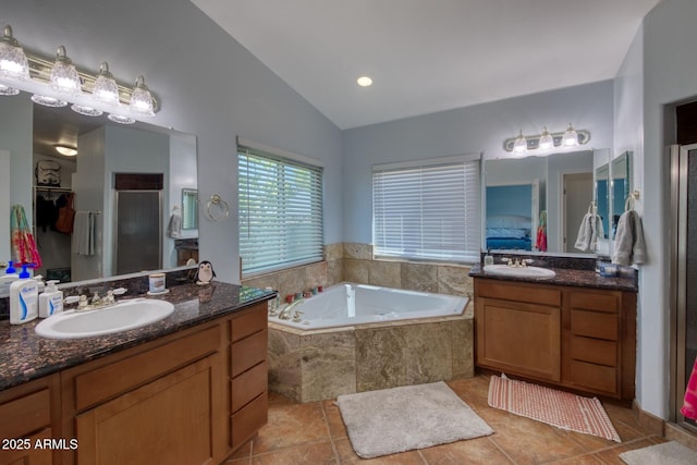 3298 W Monte Vista Trl, Benson, AZ 85602 - bathroom featuring two vanities, lofted ceiling, a garden tub, and a sink