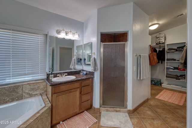 3298 W Monte Vista Trl, Benson, AZ 85602 - bathroom with tile patterned floors, visible vents, a spacious closet, a shower stall, and vanity
