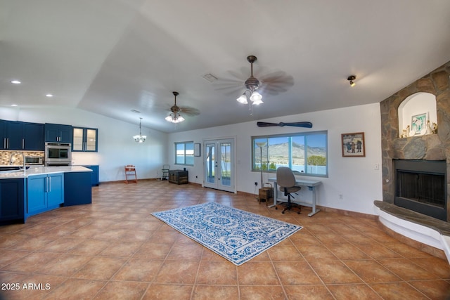 3298 W Monte Vista Trl, Benson, AZ 85602 - living room featuring lofted ceiling, visible vents, a stone fireplace, and light tile patterned floors