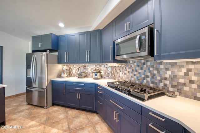 3298 W Monte Vista Trl, Benson, AZ 85602 - kitchen with light countertops, backsplash, blue cabinetry, and stainless steel appliances