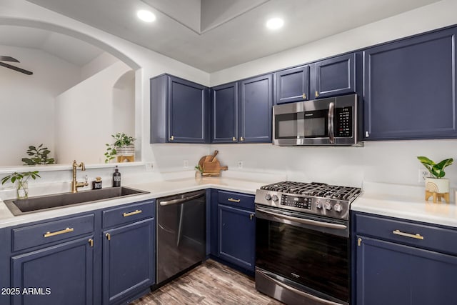 16118 W Morning Glory St, Goodyear, AZ 85338 - kitchen with appliances with stainless steel finishes, blue cabinets, wood finished floors, light countertops, and recessed lighting