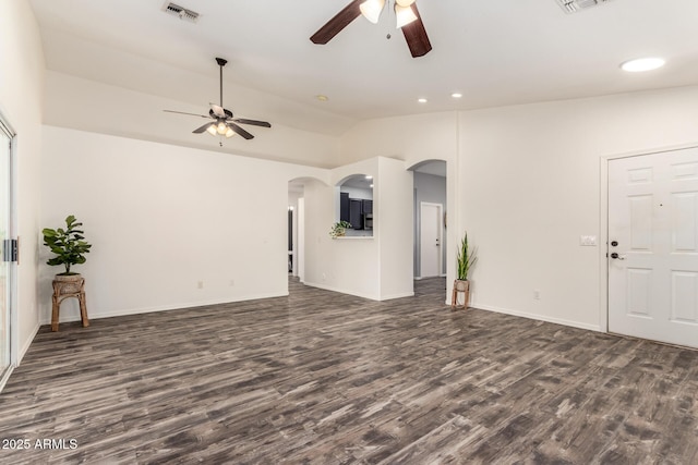 16118 W Morning Glory St, Goodyear, AZ 85338 - unfurnished living room featuring a ceiling fan, arched walkways, lofted ceiling, dark wood finished floors, and recessed lighting