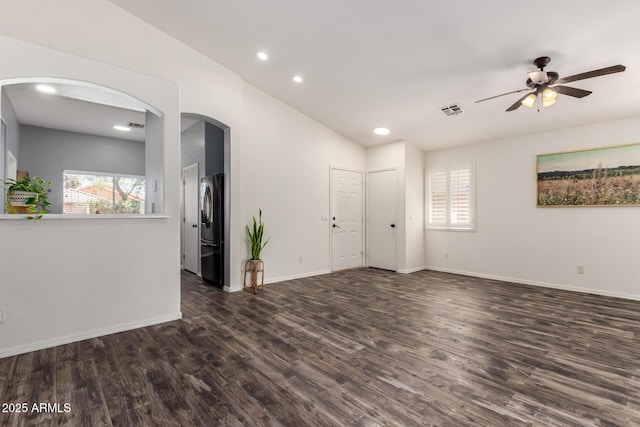 16118 W Morning Glory St, Goodyear, AZ 85338 - unfurnished room with a ceiling fan, dark wood-style floors, recessed lighting, lofted ceiling, and arched walkways