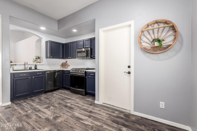 16118 W Morning Glory St, Goodyear, AZ 85338 - kitchen with stainless steel appliances, light countertops, dark wood-style flooring, and recessed lighting