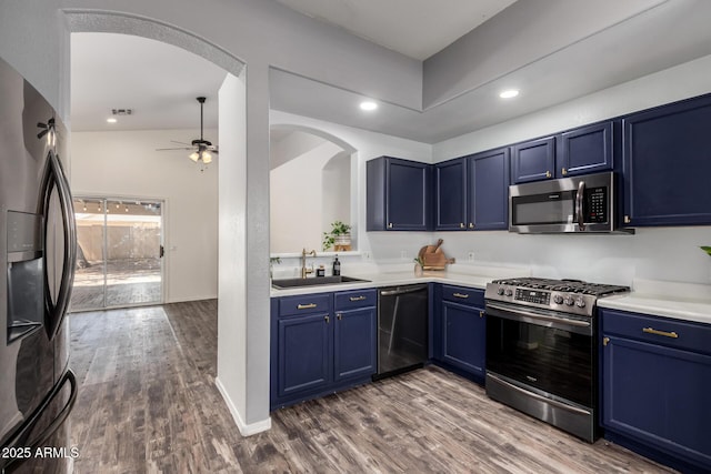 16118 W Morning Glory St, Goodyear, AZ 85338 - kitchen featuring appliances with stainless steel finishes, arched walkways, blue cabinetry, and recessed lighting
