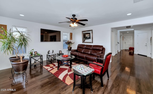 living room with ceiling fan and dark hardwood / wood-style flooring