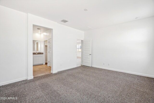 40080 W Venture Rd, Maricopa, AZ 85138 - unfurnished bedroom with ensuite bathroom and light colored carpet