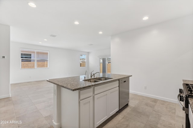 40080 W Venture Rd, Maricopa, AZ 85138 - kitchen with white cabinetry, light stone countertops, sink, stainless steel appliances, and an island with sink