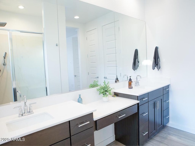 bathroom with vanity, hardwood / wood-style floors, and an enclosed shower