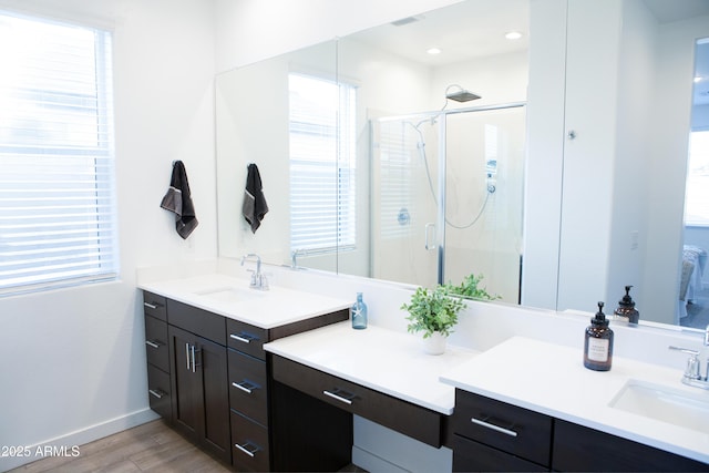 full bath with a wealth of natural light, a stall shower, and vanity