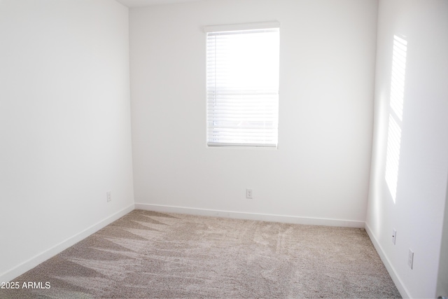 spare room with carpet floors and baseboards