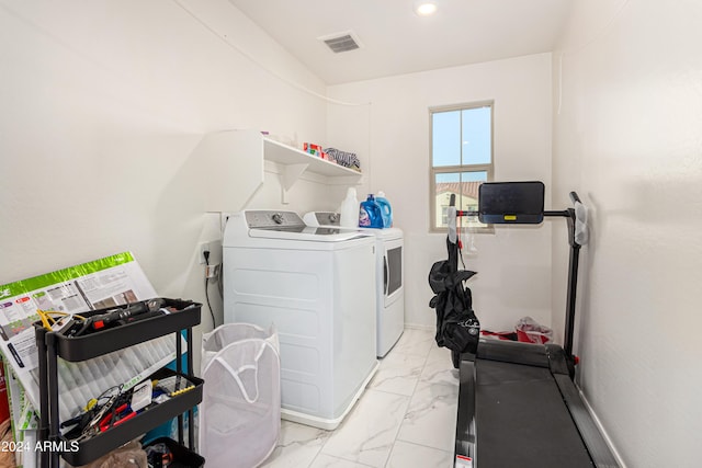 laundry room with washing machine and clothes dryer