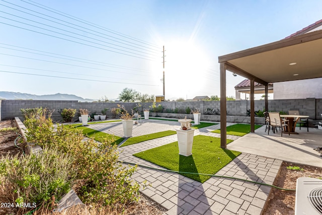 view of yard featuring a mountain view and a patio