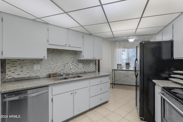 kitchen with white cabinets, appliances with stainless steel finishes, a drop ceiling, and sink