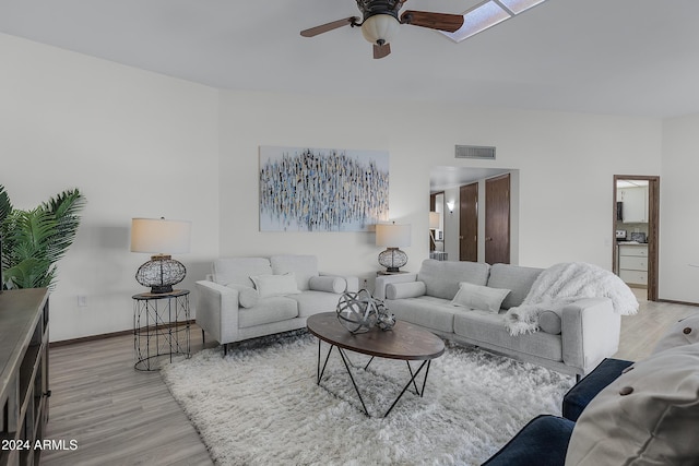 living room featuring ceiling fan and light wood-type flooring