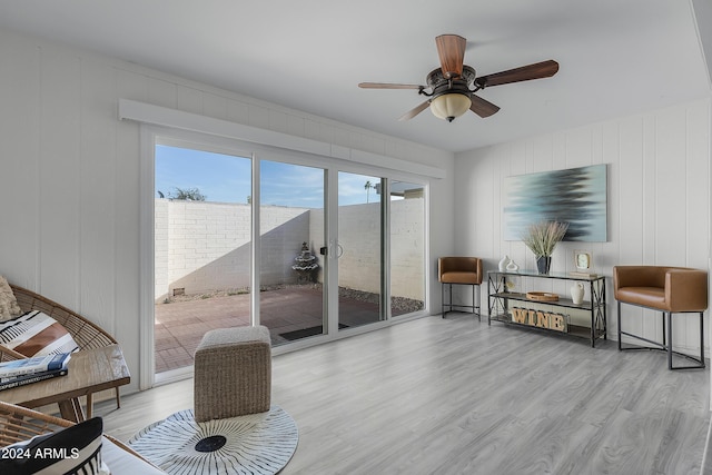 sitting room with ceiling fan and light wood-type flooring