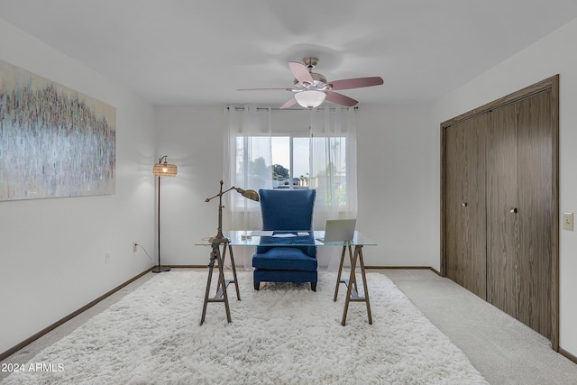 office space with ceiling fan and light carpet