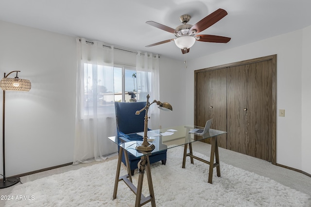 office space featuring light carpet and ceiling fan