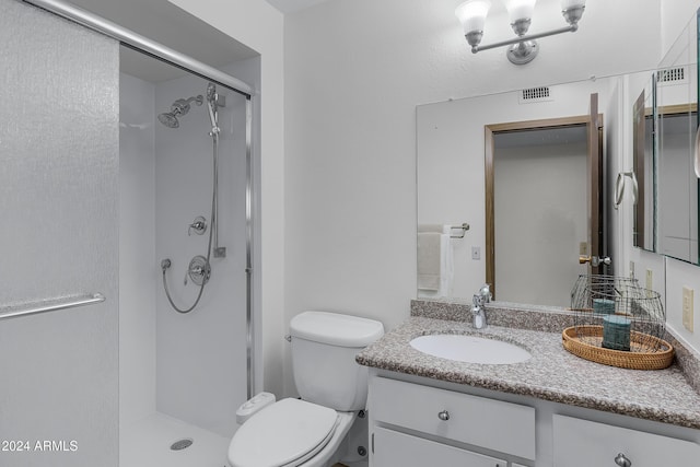 bathroom with vanity, toilet, and walk in shower