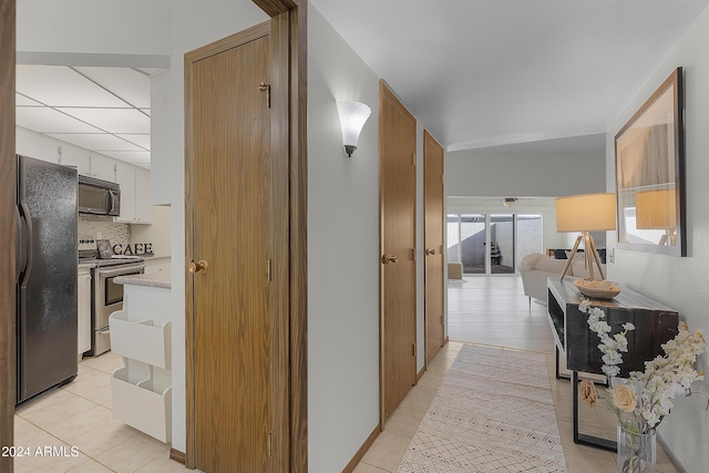 hall with light tile patterned floors