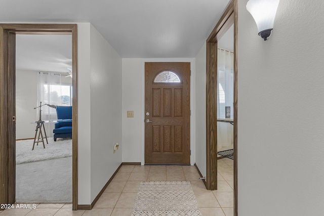carpeted entryway featuring ceiling fan