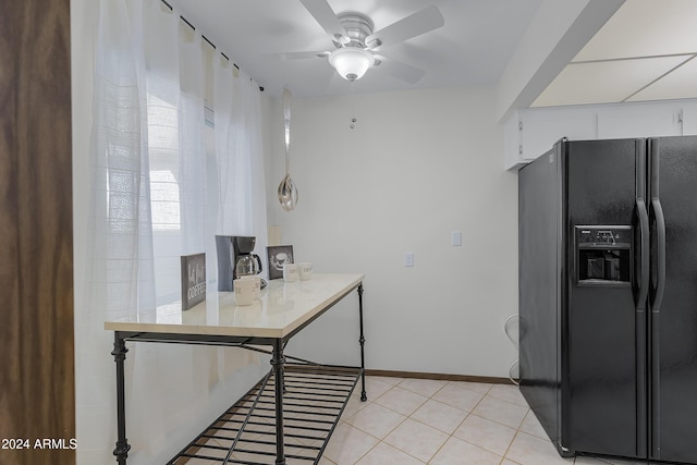 kitchen with white cabinets, light tile patterned floors, black refrigerator with ice dispenser, and ceiling fan