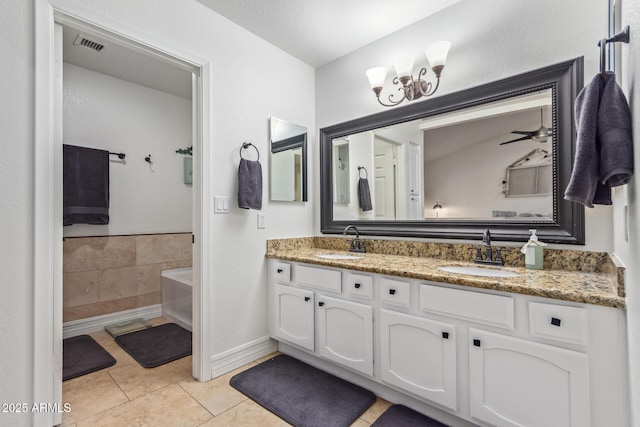 bathroom with visible vents, a sink, tile patterned floors, and double vanity
