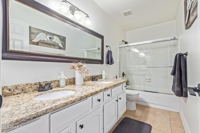 full bath with tile patterned floors, a sink, double vanity, and visible vents