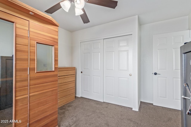 unfurnished bedroom featuring a closet, carpet floors, and a ceiling fan