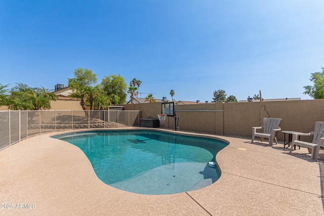 view of swimming pool featuring a patio, fence, and a fenced in pool