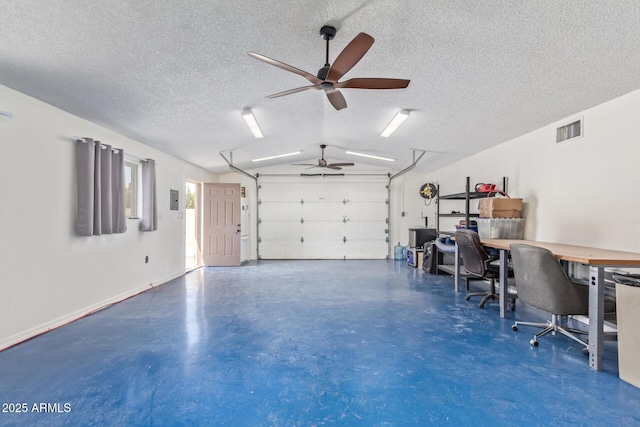 garage with baseboards, visible vents, and a ceiling fan