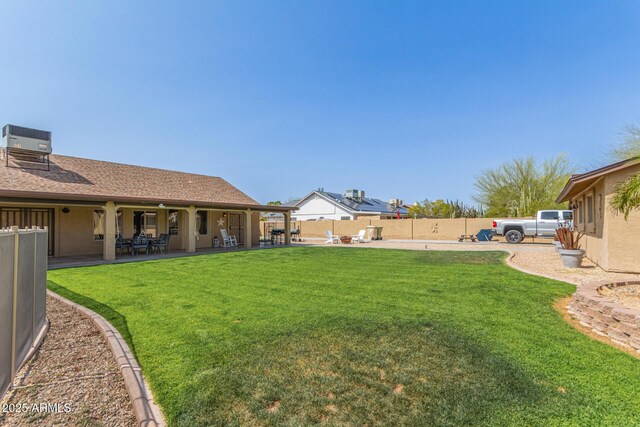 view of yard featuring a fenced backyard, central air condition unit, and a patio