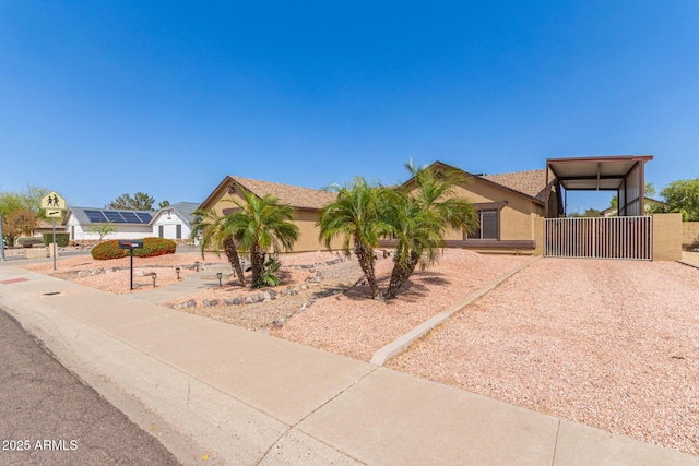 view of front of property featuring stucco siding and a gate