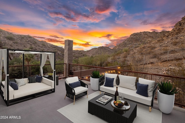 patio terrace at dusk featuring outdoor lounge area and a mountain view