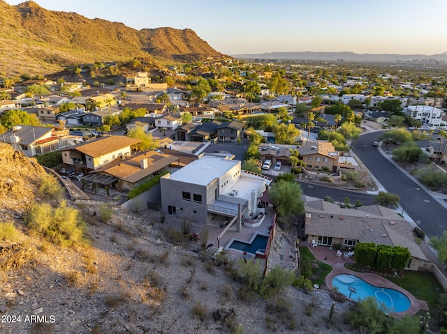 aerial view at dusk featuring a mountain view