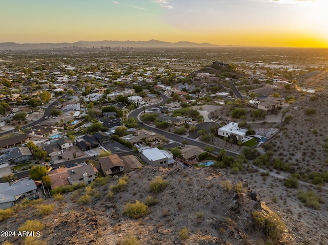 aerial view at dusk featuring a mountain view