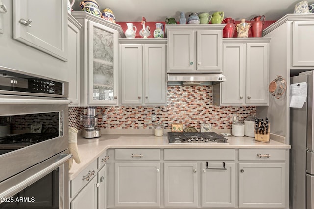 kitchen featuring light countertops, white cabinetry, backsplash, and appliances with stainless steel finishes