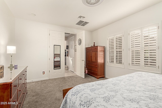 bedroom featuring visible vents, baseboards, and light colored carpet